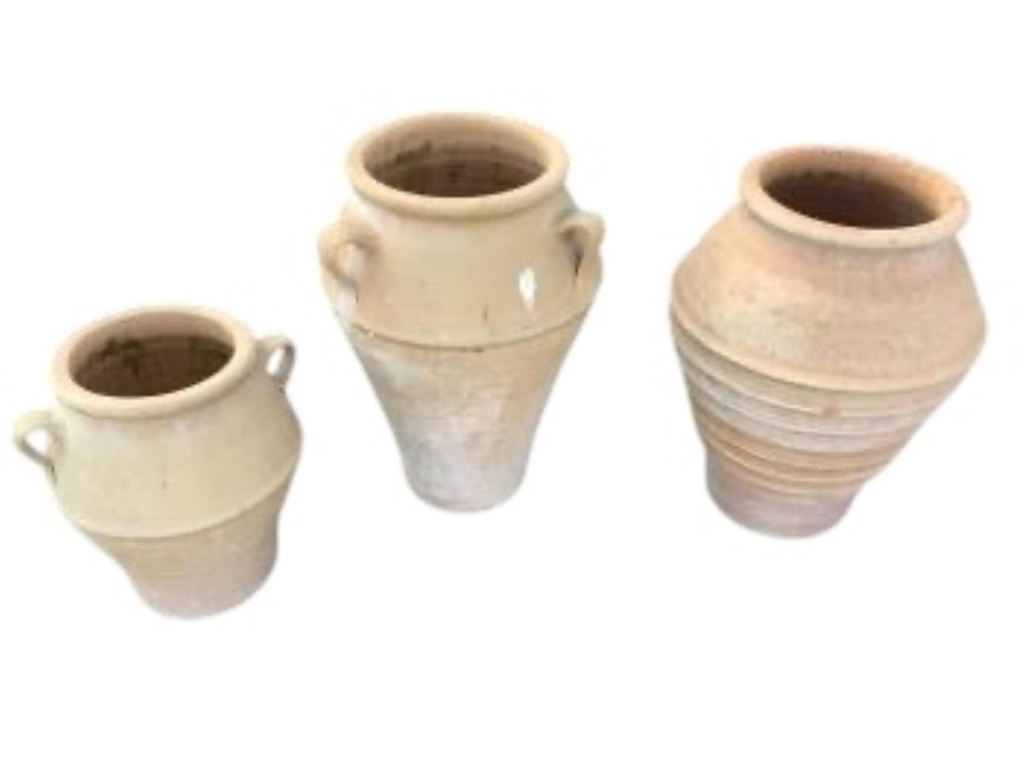 Three Grecian style circular terracotta garden planters, height 55cm